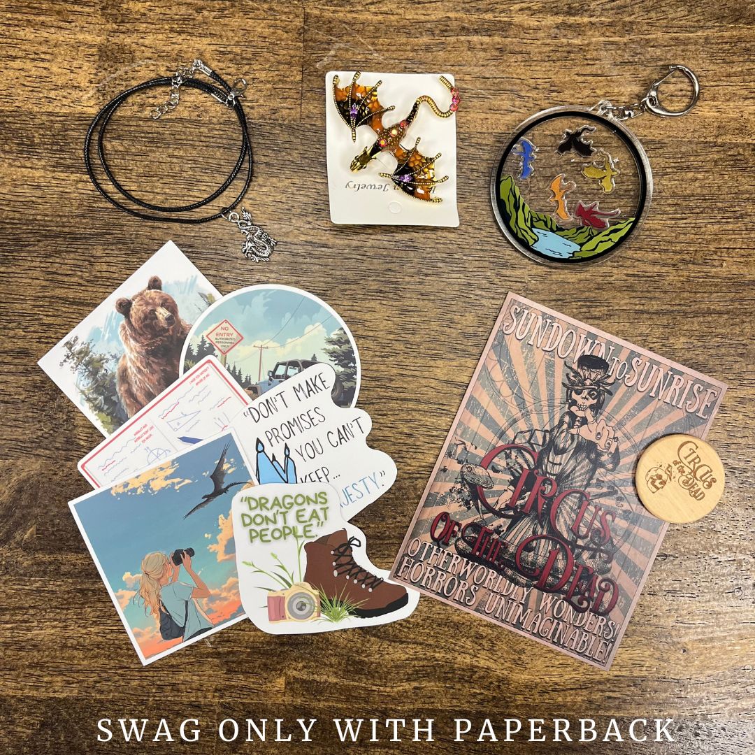 Collection of swag items including a necklace, keychain, and various cards on a wooden surface.